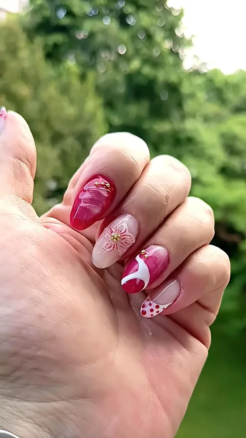 Nail art rose et blanc avec fleur 3D dorée, pois et cœurs